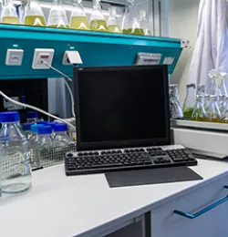 A lab environment is seen with several equipments, as well as a computer.